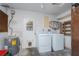 Bright laundry room featuring modern washer, dryer, and water heater for efficient home management at 39 Caddy Rd, Rotonda West, FL 33947