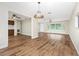 A spacious and sunny living room with hardwood floors, large windows, and an open floor plan at 39 Caddy Rd, Rotonda West, FL 33947