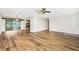 An open concept living room with hardwood flooring leads to a bright Florida room at 39 Caddy Rd, Rotonda West, FL 33947