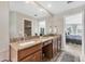Bathroom featuring dual sinks, granite countertops, and an adjoining closet at 39 Pine Valley Ct, Rotonda West, FL 33947