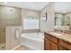 Bathroom featuring a soaking tub, walk-in shower, and a sink with granite countertops at 39 Pine Valley Ct, Rotonda West, FL 33947
