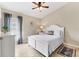 Serene bedroom with a white bed frame, neutral walls, and a light-filled window at 39 Pine Valley Ct, Rotonda West, FL 33947