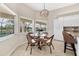 Eat-in kitchen features modern chandelier and views of the lanai at 39 Pine Valley Ct, Rotonda West, FL 33947