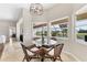 Eat-in kitchen features modern chandelier and views of the lanai at 39 Pine Valley Ct, Rotonda West, FL 33947