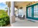 Inviting front porch with elegant columns, a double door entry, and seating at 39 Pine Valley Ct, Rotonda West, FL 33947