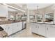 Bright kitchen featuring granite countertops, stainless steel appliances, and white cabinetry at 39 Pine Valley Ct, Rotonda West, FL 33947