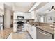 Modern kitchen with stainless appliances, granite counters, and white cabinetry at 39 Pine Valley Ct, Rotonda West, FL 33947
