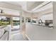 Open kitchen featuring granite countertops and views of the backyard pool area at 39 Pine Valley Ct, Rotonda West, FL 33947