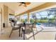 Inviting screened lanai area with seating and a grill, overlooking the pool and backyard at 39 Pine Valley Ct, Rotonda West, FL 33947