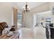Spacious living room with tile flooring, tall ceilings and large window at 39 Pine Valley Ct, Rotonda West, FL 33947