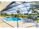 Beautiful pool with attached spa under screened in enclosure with lush backyard views at 39 Pine Valley Ct, Rotonda West, FL 33947