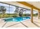 Inviting pool area with a spa, screened enclosure, and serene backyard views at 39 Pine Valley Ct, Rotonda West, FL 33947
