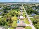 Overhead view of the house showcasing the pool, lanai, large lawn and surrounding neighborhood at 4221 Ulster Ave, North Port, FL 34287