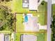 Overhead view of the property showcasing the pool, lanai, manicured lawn and driveway at 4221 Ulster Ave, North Port, FL 34287