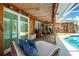 A covered patio with a lounge chair overlooks the pool for ultimate relaxation and comfort at 4221 Ulster Ave, North Port, FL 34287