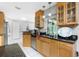 Well-equipped kitchen with wooden cabinets, granite countertops, stainless steel appliances, and open layout at 4221 Ulster Ave, North Port, FL 34287