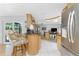 Kitchen area with bar seating adjacent to a sliding glass door leading to outdoor space at 4221 Ulster Ave, North Port, FL 34287