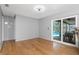 Spacious living room with hardwood floors and glass sliding doors to outside pool area at 4221 Ulster Ave, North Port, FL 34287