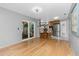 Open floor plan living room with hardwood flooring leading into kitchen area at 4221 Ulster Ave, North Port, FL 34287