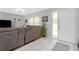Comfortable living room with neutral colors, tile flooring, a modern ceiling fan, and ample natural light at 4221 Ulster Ave, North Port, FL 34287