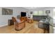 Cozy living room features hardwood floors, comfortable seating, and natural lighting through bright windows at 4221 Ulster Ave, North Port, FL 34287