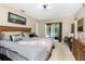 This main bedroom offers a decorative headboard and sliding door access to the refreshing pool at 4221 Ulster Ave, North Port, FL 34287