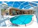 Inviting screened-in pool area with a covered patio and ample seating, perfect for outdoor entertaining at 4221 Ulster Ave, North Port, FL 34287