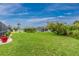 Spacious backyard with a glimpse of the screened-in pool, complemented by well-maintained lawn and landscaping at 4227 Winona St, Port Charlotte, FL 33948