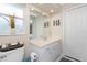 Bathroom featuring vanity with quartz counters and storage and updated fixtures at 4227 Winona St, Port Charlotte, FL 33948