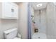 Bathroom featuring toilet, cabinet, walk in shower, shower niche, and grey curtain at 4227 Winona St, Port Charlotte, FL 33948