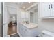 Bathroom view with a white vanity, toilet, and an open door to a bedroom at 4227 Winona St, Port Charlotte, FL 33948