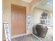 Charming front entryway with a decorated door, tiled porch, and a decorative welcome sign at 4227 Winona St, Port Charlotte, FL 33948