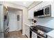 Bright kitchen featuring white cabinets, stainless steel appliances, and tile flooring at 4227 Winona St, Port Charlotte, FL 33948