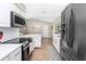 Well-equipped kitchen with stainless steel appliances, white cabinetry, and plenty of counter space at 4227 Winona St, Port Charlotte, FL 33948