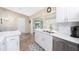 Bright kitchen featuring a stainless steel sink under a window, complemented by white cabinets at 4227 Winona St, Port Charlotte, FL 33948
