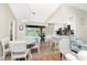 Open concept kitchen with white cabinets, stainless steel appliances, and a view of the pool area at 4227 Winona St, Port Charlotte, FL 33948