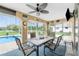 Outdoor lanai featuring decorative walls, a ceiling fan, stone floors, a pool view, and plenty of room for dining at 4227 Winona St, Port Charlotte, FL 33948