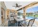 Outdoor lanai featuring decorative walls, a ceiling fan, stone floors, a pool view, and plenty of room for dining at 4227 Winona St, Port Charlotte, FL 33948
