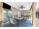 Outdoor lanai featuring decorative walls, a ceiling fan, stone floors, a pool view, and plenty of room for dining at 4227 Winona St, Port Charlotte, FL 33948