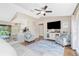 Open living room with large TV, hardwood floors, and comfortable seating, transitioning to the kitchen at 4227 Winona St, Port Charlotte, FL 33948