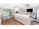 Bright living room with a ceiling fan, vaulted ceiling, and view of the kitchen and patio at 4227 Winona St, Port Charlotte, FL 33948