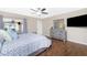 Comfortable main bedroom with wood floors, ceiling fan, sliding doors, and a gray dresser and a mirror at 4227 Winona St, Port Charlotte, FL 33948
