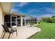 Outdoor patio area with seating near the screened pool, perfect for relaxing and enjoying the beautiful backyard at 4227 Winona St, Port Charlotte, FL 33948