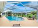 Screened-in pool area with clear water and inviting lounge chair, perfect for enjoying sunny days and relaxation at 4227 Winona St, Port Charlotte, FL 33948