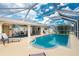 Beautiful backyard pool with screened enclosure and relaxing lounge chairs, creating the perfect outdoor oasis at 4227 Winona St, Port Charlotte, FL 33948