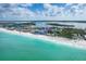 Beautiful aerial view of beachfront condos with clear turquoise water and bright sky at 50 Meredith Dr # 9, Englewood, FL 34223