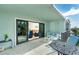 Spacious balcony featuring an outdoor seating area and sliding glass doors to the living room at 50 Meredith Dr # 9, Englewood, FL 34223