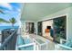 Outdoor balcony features comfortable seating with views of the ocean and palm trees at 50 Meredith Dr # 9, Englewood, FL 34223
