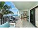 Charming balcony featuring comfortable seating, with beautiful ocean views and lush palm trees at 50 Meredith Dr # 9, Englewood, FL 34223