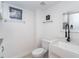 Bright half-bathroom featuring a farmhouse sink, black faucet, and white marble countertops at 50 Meredith Dr # 9, Englewood, FL 34223